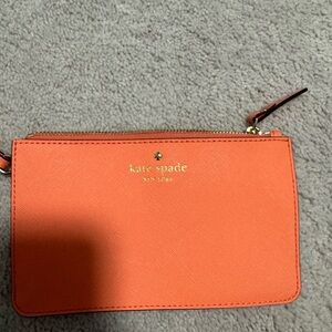 Kate Spade wristlet. Perfect summer accessory in a coral orange/pink color.